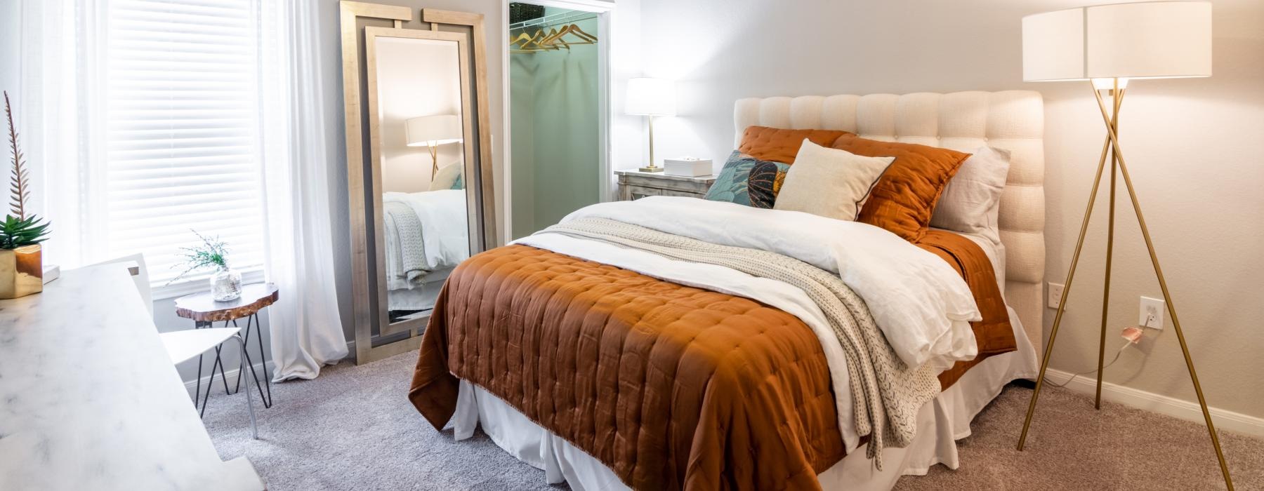a bedroom with a fan and a bed