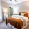 a bedroom with a fan and a bed