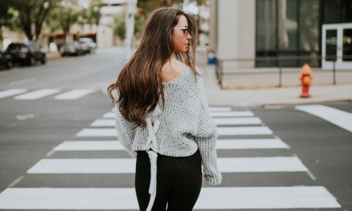 Close to the center of everything a person walking in a crosswalk